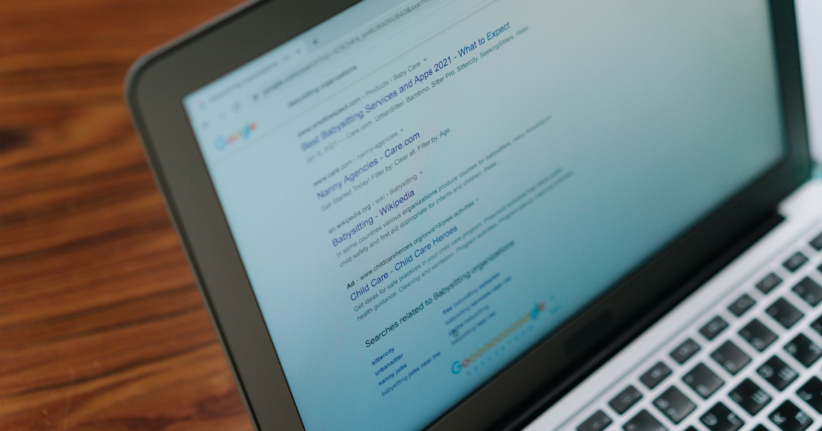A close-up view of a laptop displaying a search engine page.