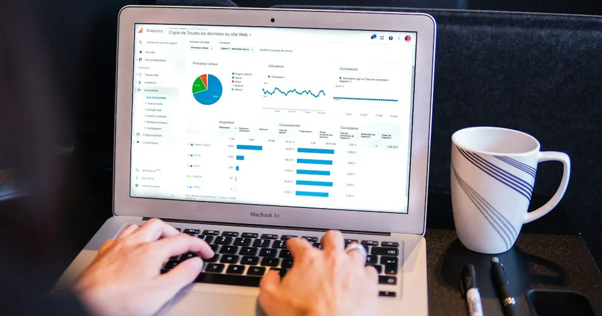 person using macbook pro on black table