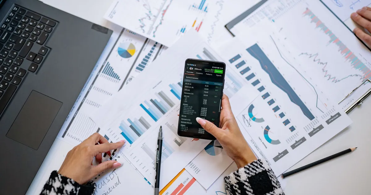 A top view on charts and smartphone in an office, showcasing data analytics.