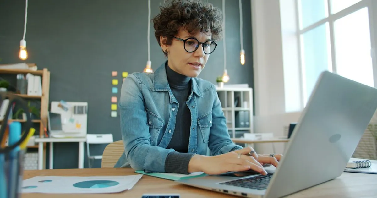 Woman working on a laptop in a modern office