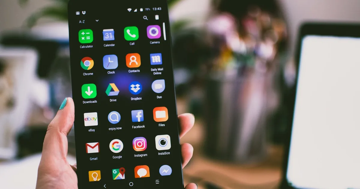 Person browsing a mobile website on a smartphone outdoors.