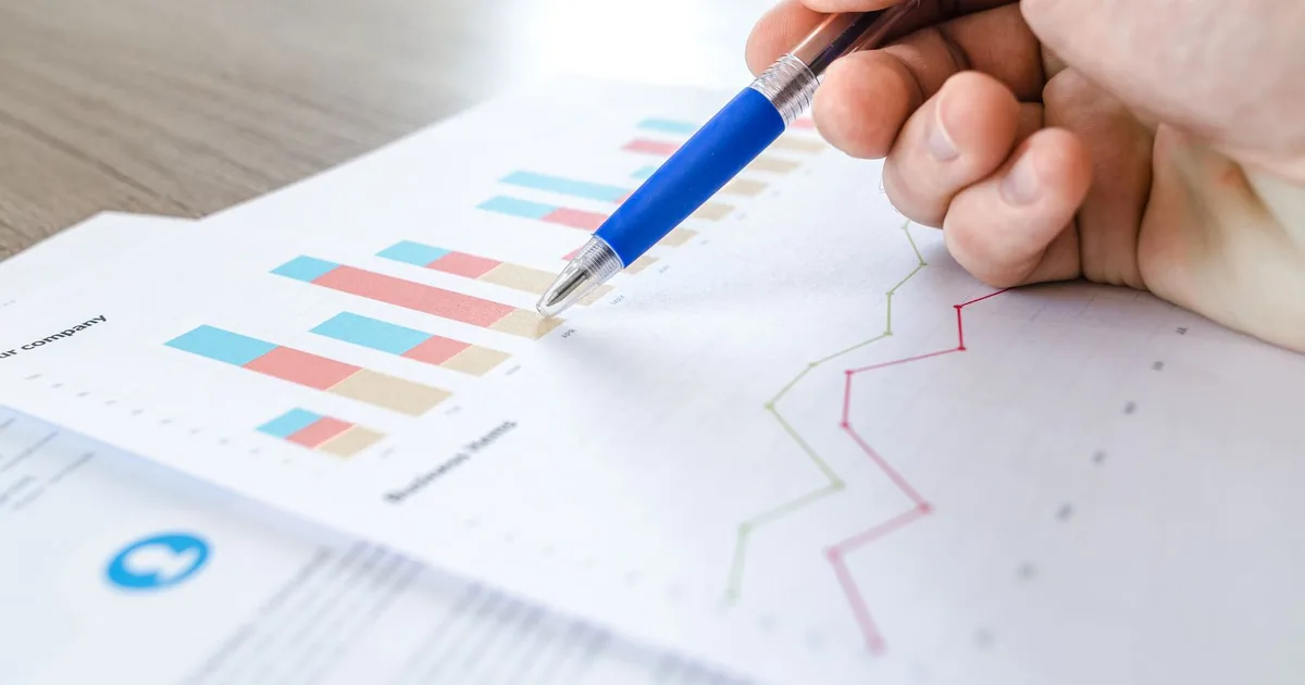 Analytics funnel charts printed and reviewed on a desk.