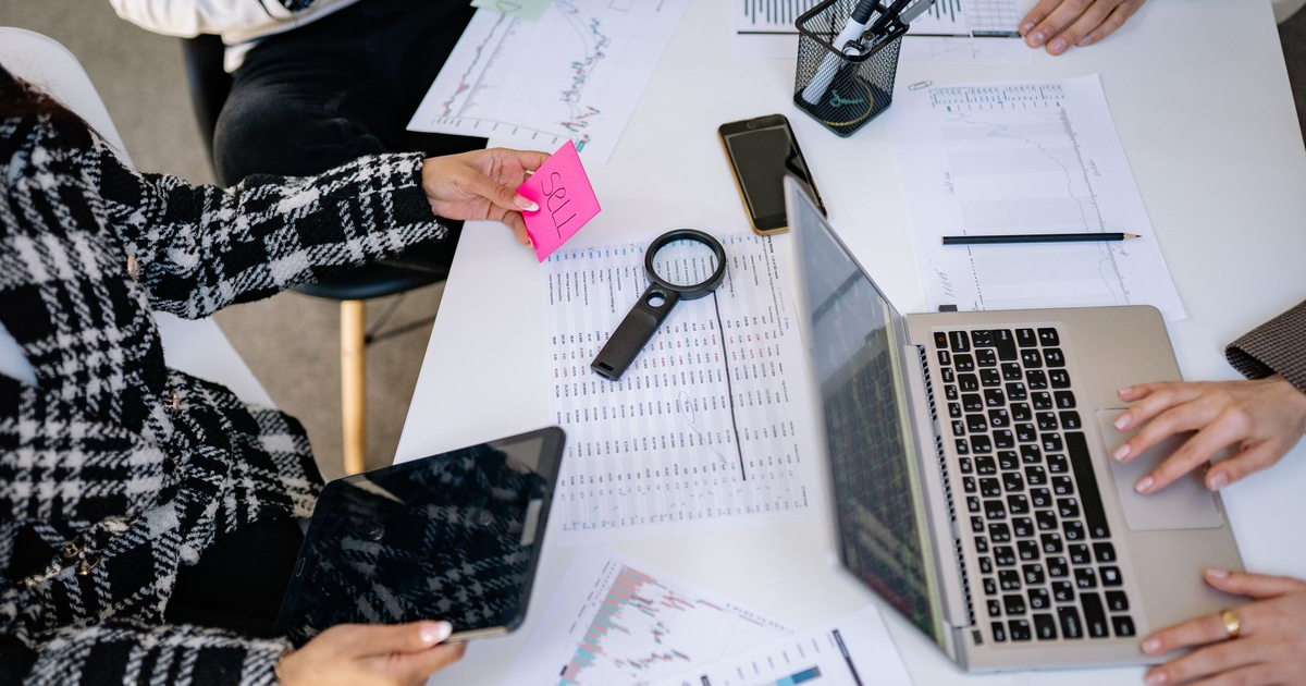 Business professionals collaborating on financial data analysis in a modern office setting.